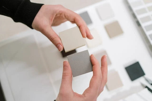 a-person-looking-at-paint-and-tile-samples